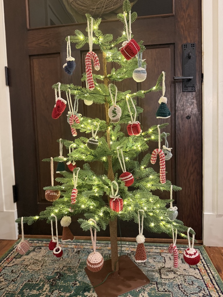 A small tree covered in handmade crochet ornaments